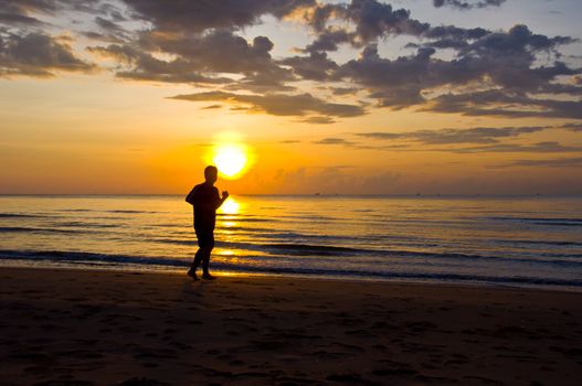 silhouette of man running on the beach