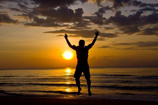 silhouette of man feel free and happy on the beach