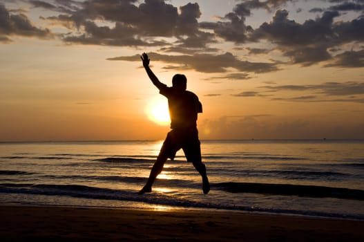 silhouette of man feel free and happy on the beach