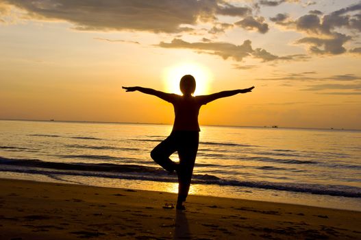 silhouette of woman Yoga on the beach