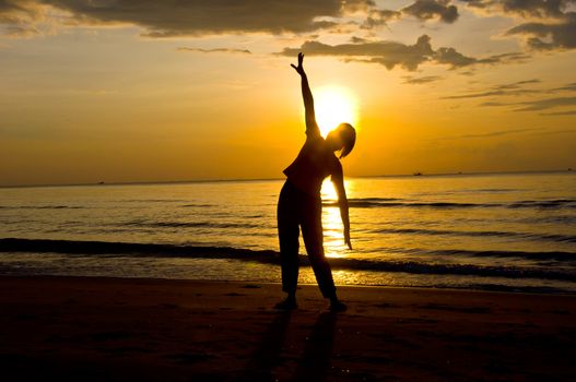 silhouette of woman Yoga on the beach