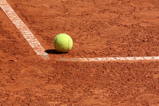 ball lying in corner of tennis court