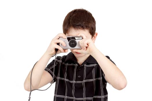 small boy photographing horizontal with digital camera on white background