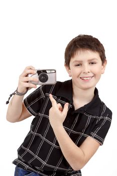 small boy showing analog camera on white background