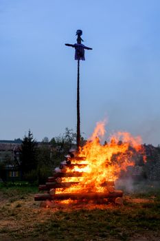 walpurgis night burning wood and religion cross with huge flames