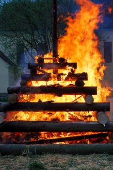 walpurgis night burning wood and religion cross with huge flames