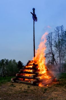 walpurgis night burning wood and religion cross with huge flames