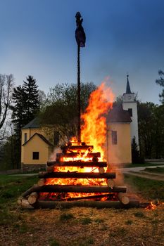 walpurgis night burning wood and religion cross with huge flames