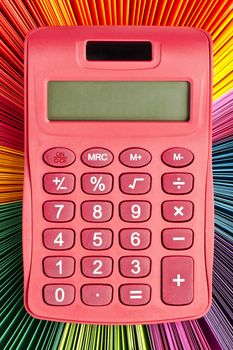 Detailed shot of pink calculator and color palette.