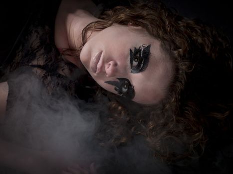 Gothic woman laying in fog-  MUA: Amanda Wynne - www.awynnemakeup.com