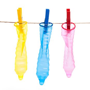 Colorful condoms with clothespins on a rope