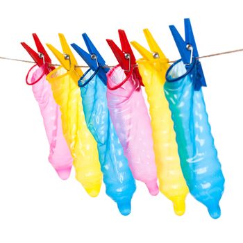 Colorful condoms with clothespins on a rope
