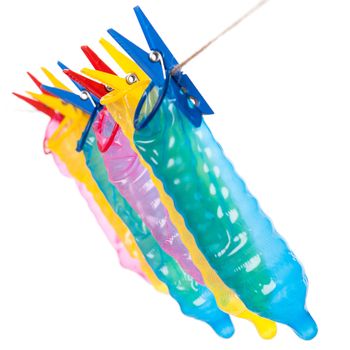 Colorful condoms with clothespins on a rope