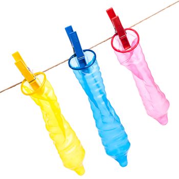 Colorful condoms with clothespins on a rope