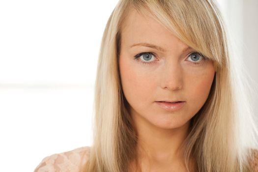 Young attractive woman posing over grey background