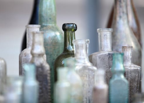 several old bottle on the table close to