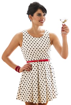young woman with retro look holding a martini drink in the motion of a toast