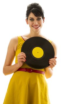 young woman in a yellow dress, looking over a record with a yellow label