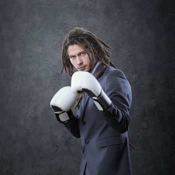 Businessman with boxe glove ready to fight