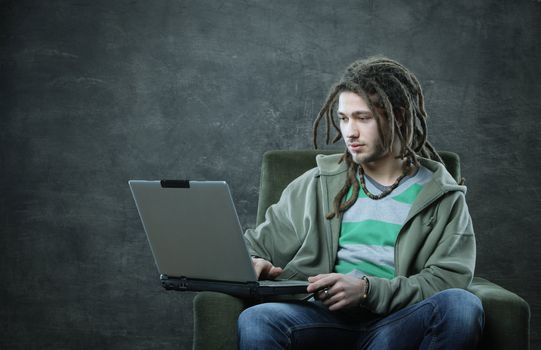 Young man student working with his laptop