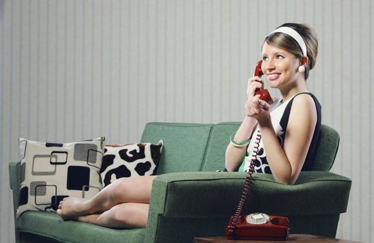 Attractive young woman on couch  talking on the phone