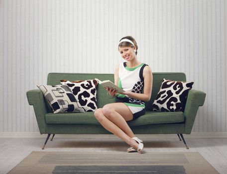 Girl sitting on the couch with a book