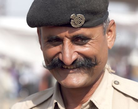 PUSHKAR, INDIA - NOVEMBER 21: Portrait of a police officer on the Pushkar fair on November 21, 2012 in Pushkar, Rajasthan, India.