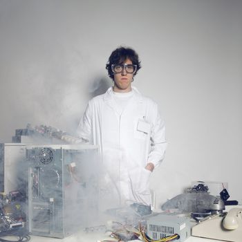 Portrait of a Computer technician with a computer destroyed