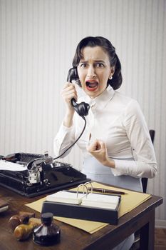 Scared Young Woman shouting into telephone