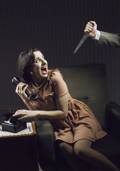 Terrified woman by a man murderess with a knife