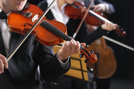 Symphony music, violinist at concert, hand close up