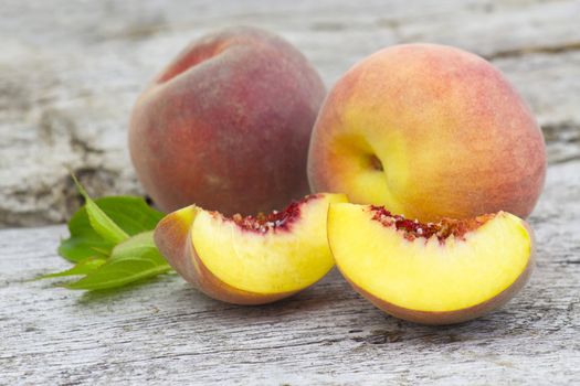 fresh peaches on old wooden background