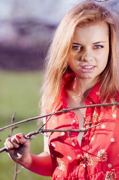 Beautiful woman in a red blouse unbuttoned