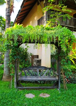 Wooden chair in tropical garden