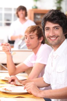 Young men eating a meal