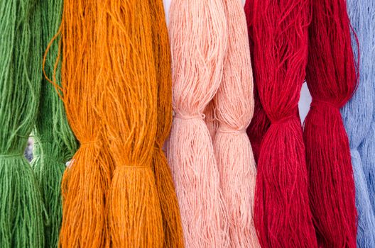 background of various colors wool threads closeup.