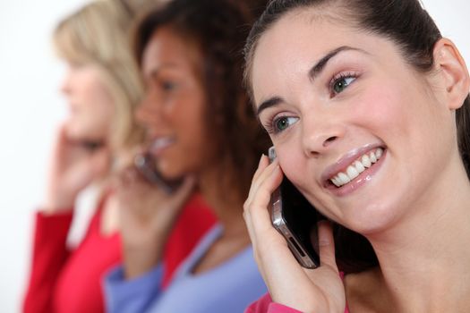 Portrait of three women on the phone