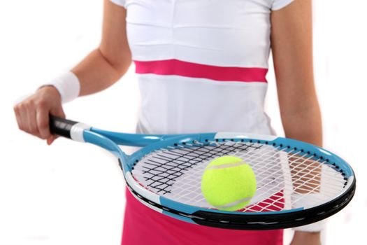 Tennis player holding her racket and ball