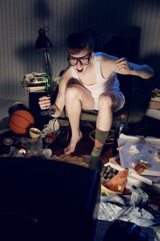 A excited teen plays video console games on His television
