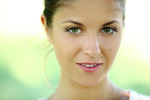 Beautiful young caucasian woman on a green background