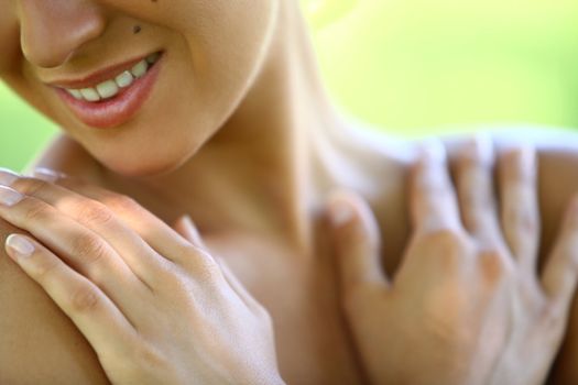 Beautiful young caucasian woman's chest and neck on a green background