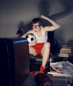 Nerd boy excited by goal scored during soccer competition