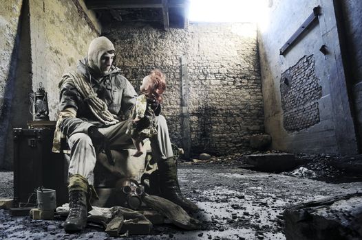 Soldier with an old doll in hand in the ruins