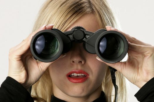 Blonde woman looking throgh binoculars