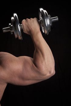 Body builder lifting dumbbell