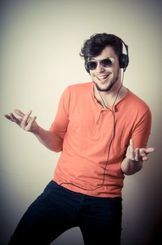 Stylish man listening to music on vignetting background