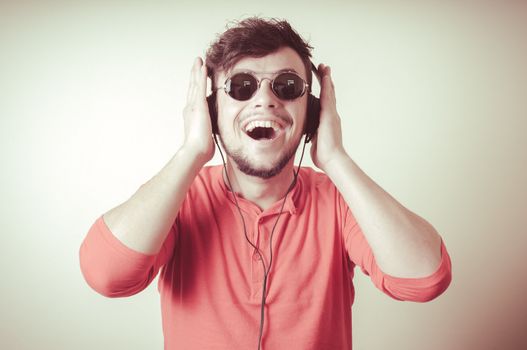Stylish man listening to music on vignetting background