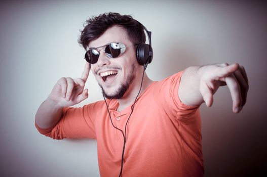 Stylish man listening to music on vignetting background