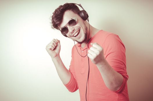 Stylish man listening to music on vignetting background