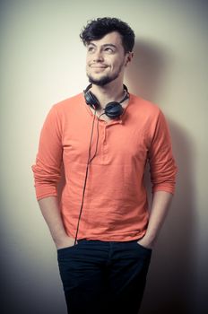 Stylish man listening to music on vignetting background
